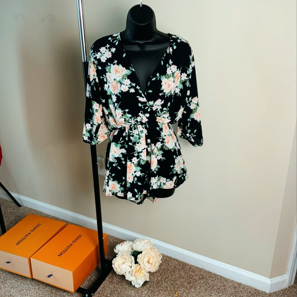 Floral romper with V-neck front and open back.